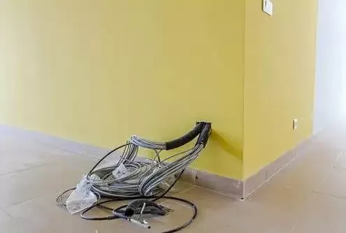 Engineer installing structured data cabling in a Leeds commercial office