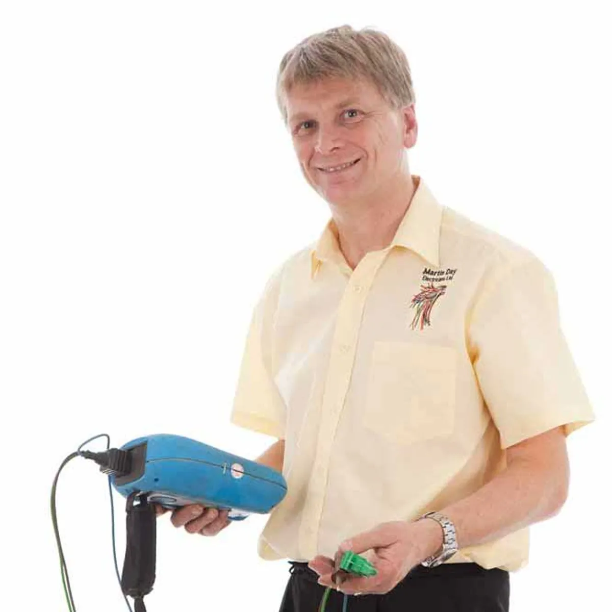 Martin Day, NICEIC-approved commercial electrician in Leeds, holding a multimeter and test plug
