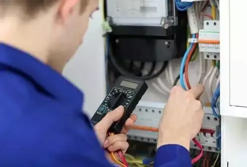 Engineer performing planned preventative electrical maintenance on a commercial site